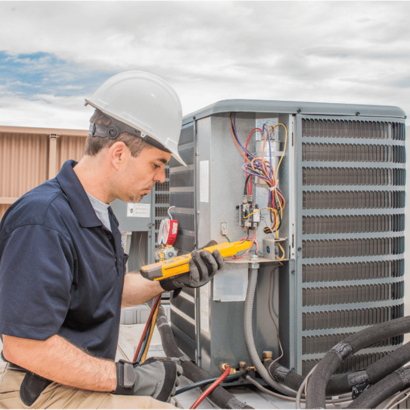 Ayr Heating & Cooling HVAC technician servicing a system