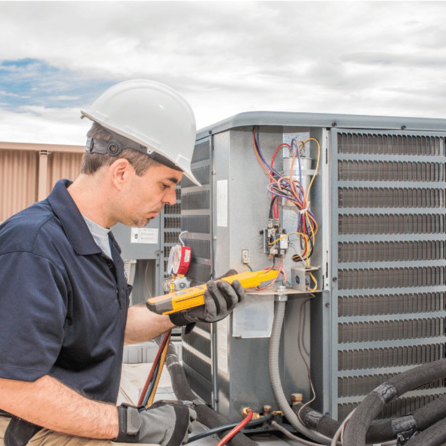 Ayr Heating & Cooling HVAC technician servicing a system
